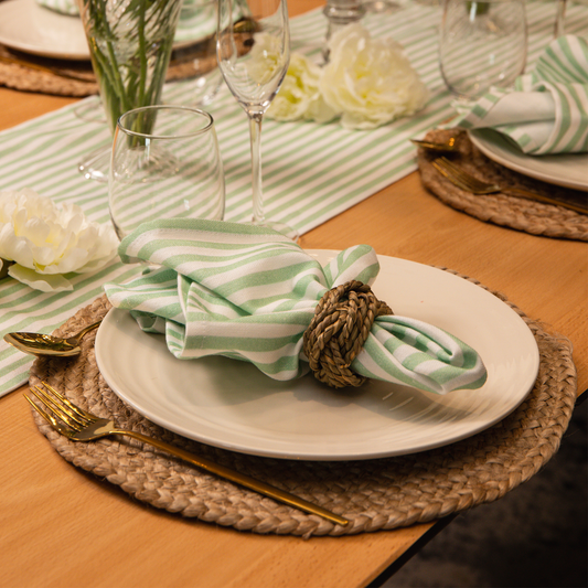 Top tables green strip napkin on jute placemat with Emily green stripe table runner. 